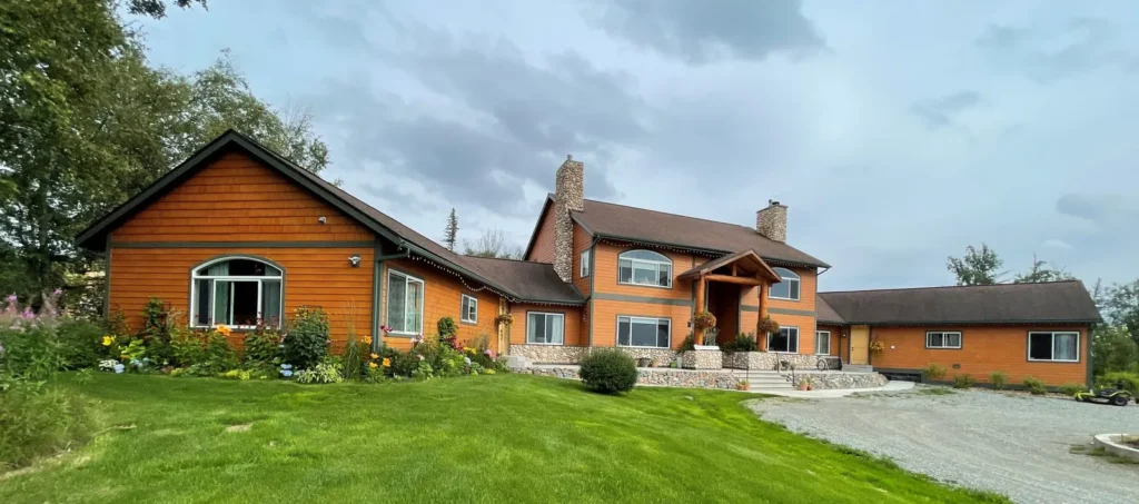 Front view of Lazy Mountain Acres with mountains behind