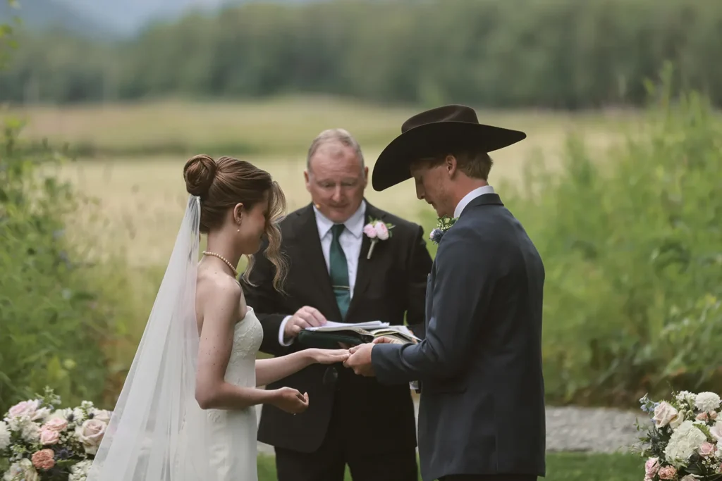 Couple exchanging vows outdoors at Lazy Mountain Acres