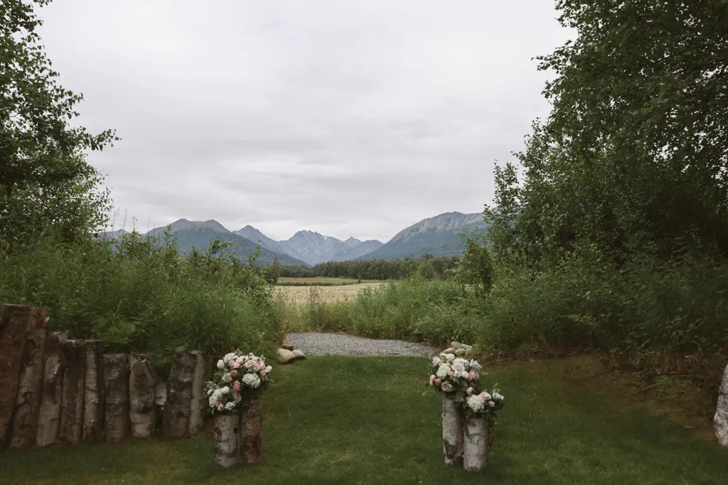 Bride and groom walking through the peony field