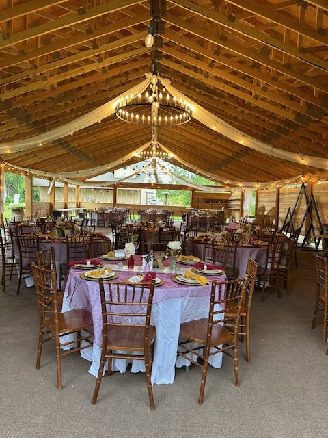 Round tables with Chiavari chairs set under the pavilion's draped ceiling
